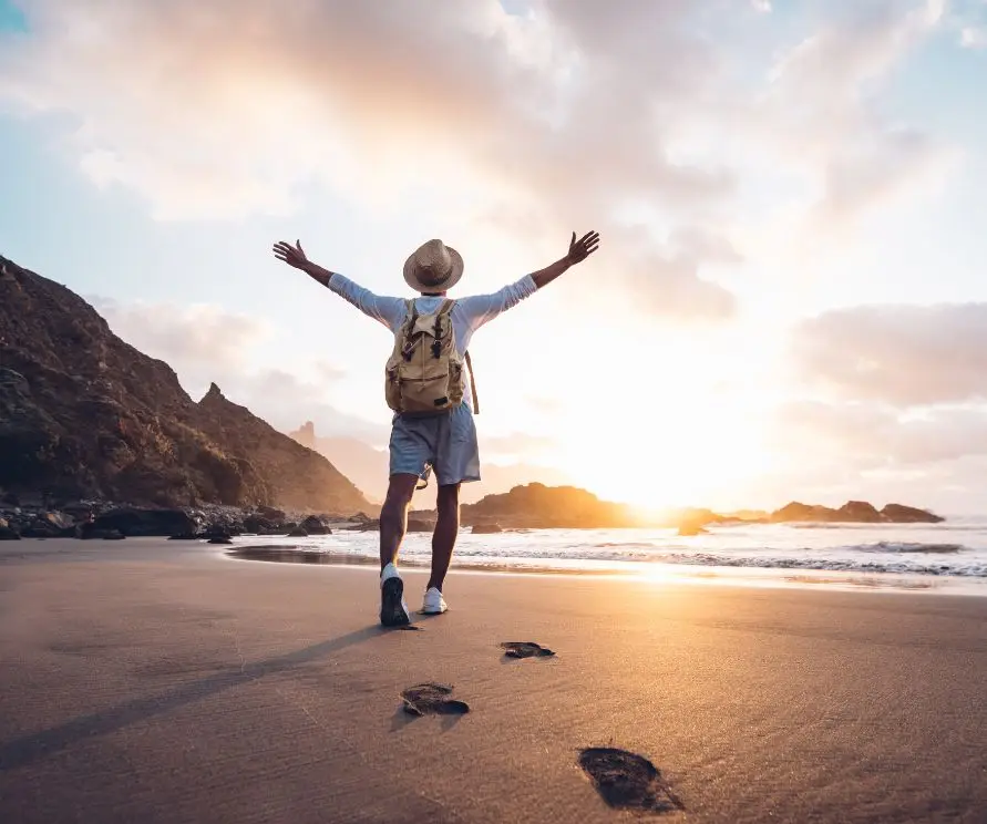 Person walking on the beach during a holiday