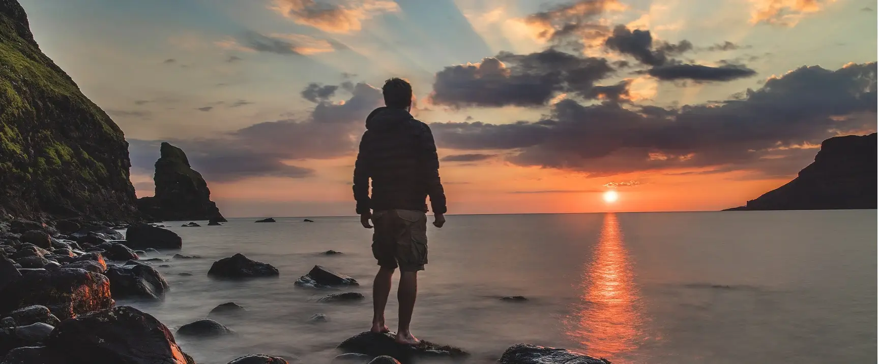 man looking at a beautiful sunset